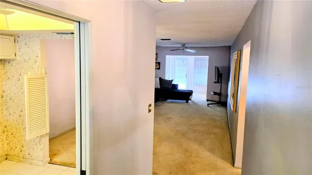 a view of a kitchen with white cabinets and white appliances