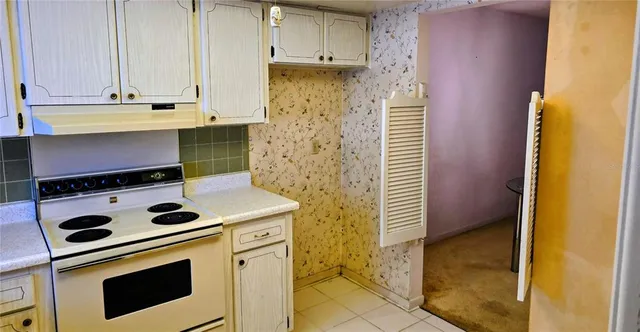 a kitchen with cabinets and window