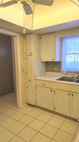 a kitchen with granite countertop cabinets and white stainless steel appliances