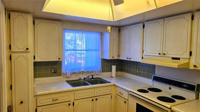 a kitchen with a sink and a refrigerator
