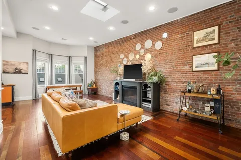 a living room with fireplace furniture and a flat screen tv