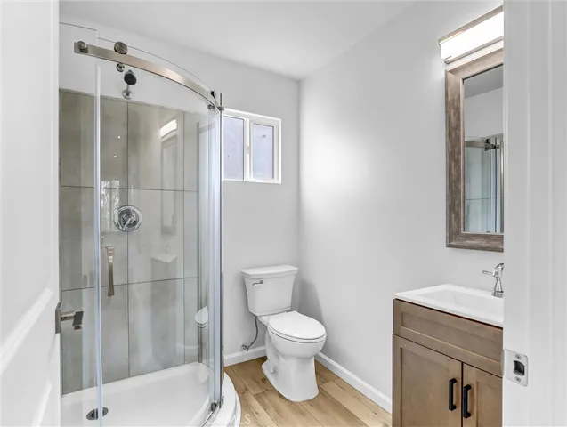 a bathroom with a shower a toilet and a sink