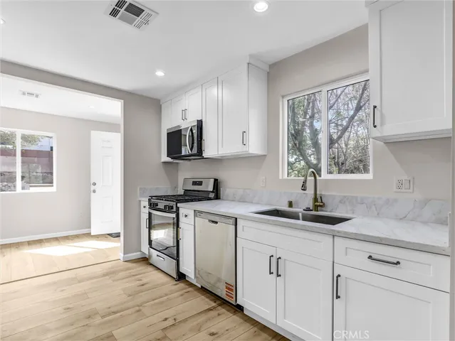 a kitchen with a sink stove and cabinets