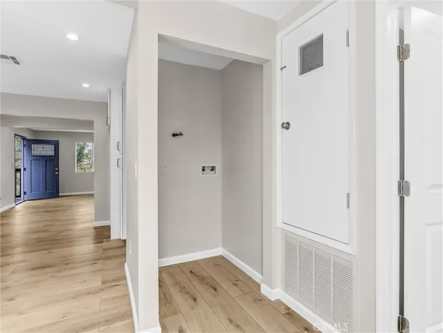 a view of a hallway with wooden floor