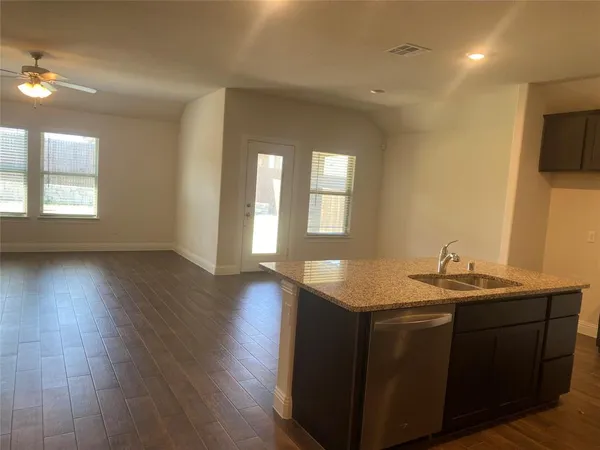 a view of a kitchen counter space and wooden floor