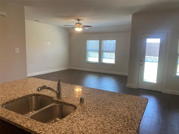 a kitchen with a sink cabinets and chandelier