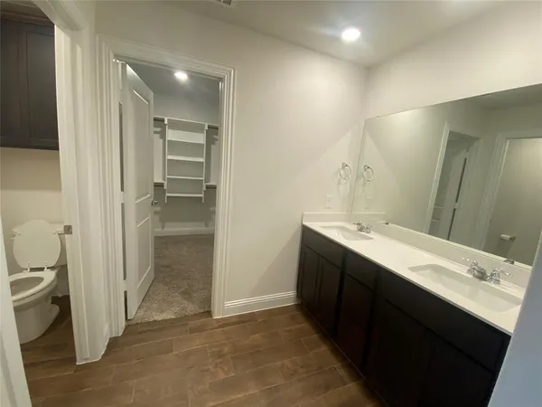 a bathroom with a double vanity sink toilet and shower