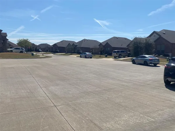a view of a lake and a car parked on the roadside