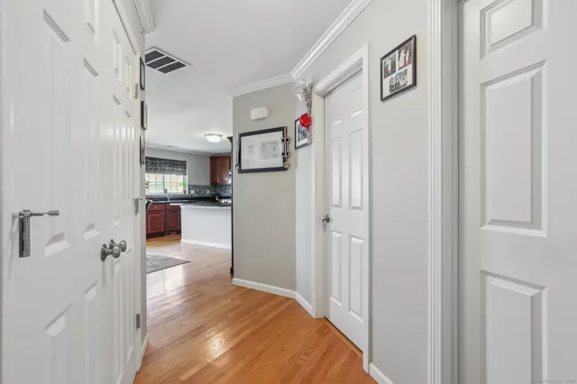 a view of a kitchen and an empty room
