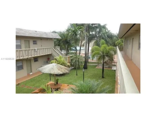 a view of a backyard with a garden and plants