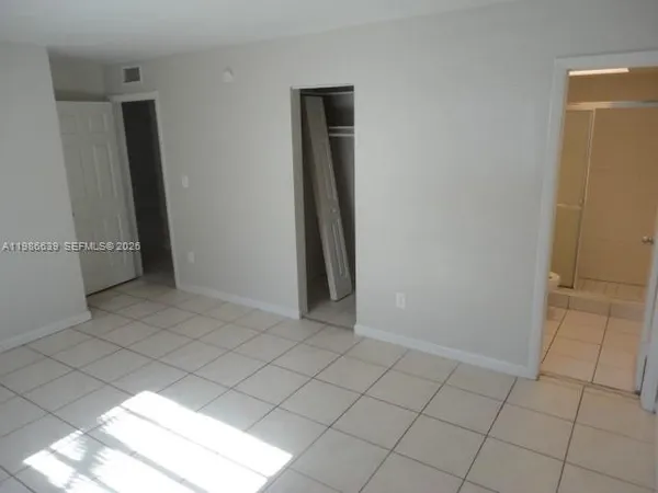 an empty room with wooden floor