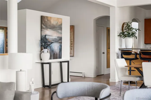 a living room with furniture a flat screen tv and a floor to ceiling window