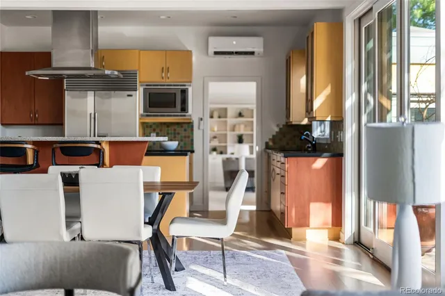 a living room with furniture a flat screen tv and a floor to ceiling window