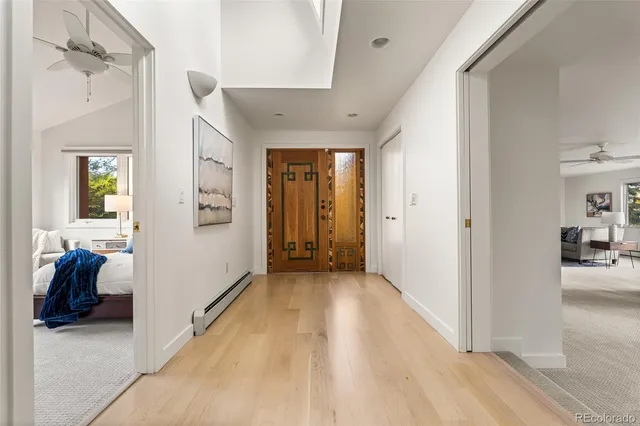 a living room with furniture a flat screen tv and a large window