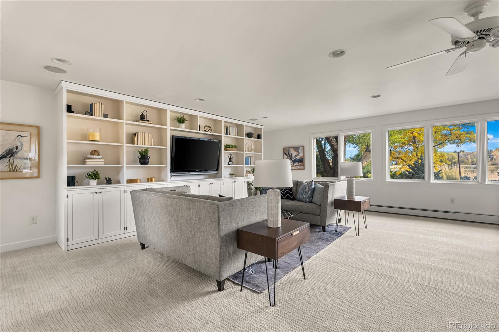 700 Utica Avenue Boulder, CO 80304 - Photo 33 of 50 a living room with furniture a flat screen tv and a large window