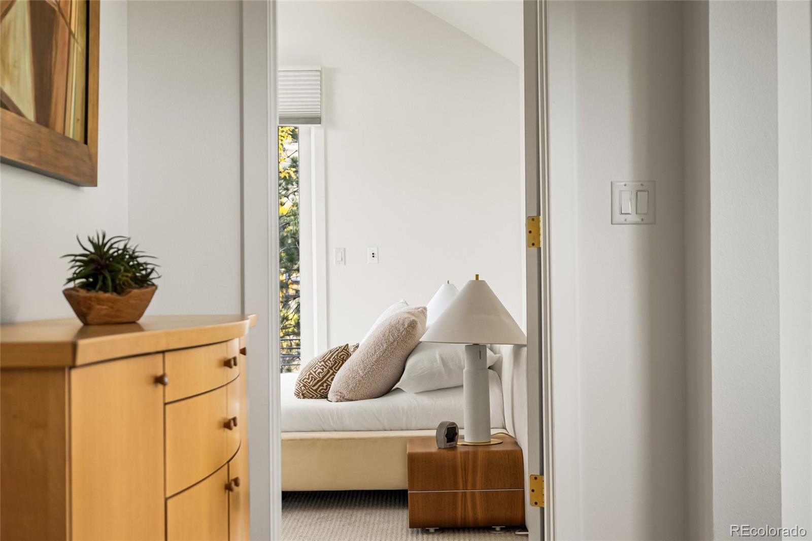 700 Utica Avenue Boulder, CO 80304 - Photo 40 of 50 a bedroom with a bed and a potted plant