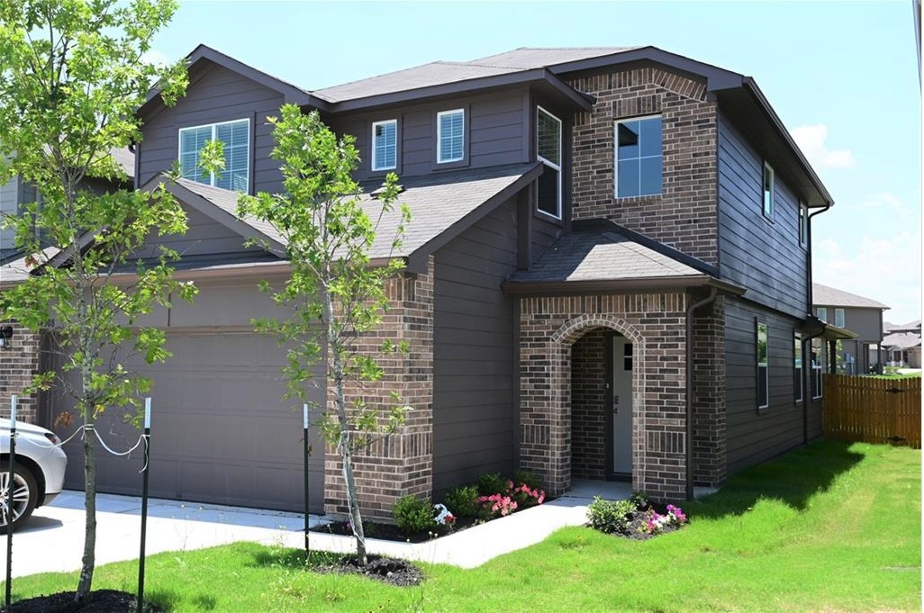 A striking exterior combines rich brickwork with contemporary siding, offering strong curb appeal.