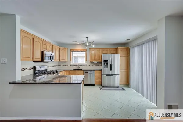 a kitchen with refrigerator and cabinets