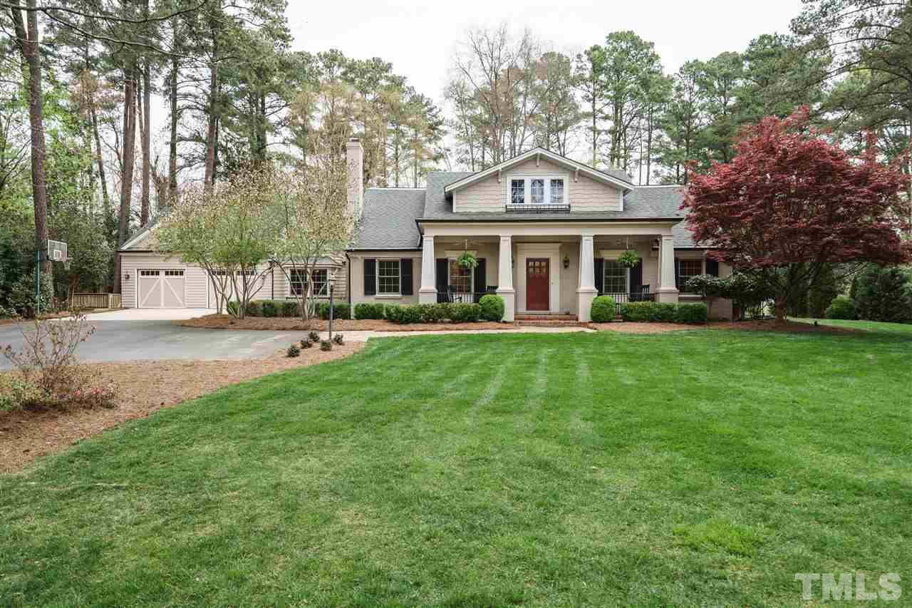 3202 Birnamwood Road Raleigh, NC 27607 - Photo 1 of 25 a front view of a house with a garden and trees