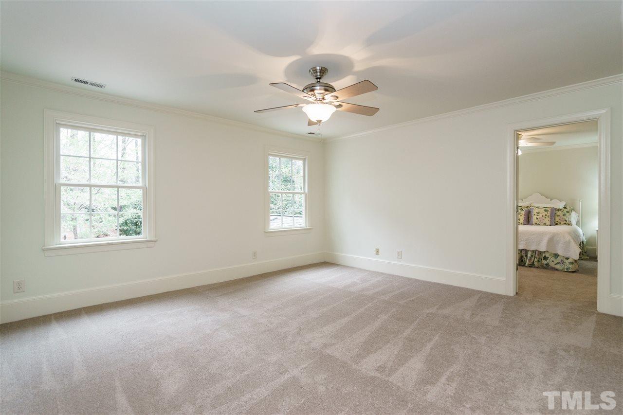 3202 Birnamwood Road Raleigh, NC 27607 - Photo 15 of 25 an empty room with windows and fan
