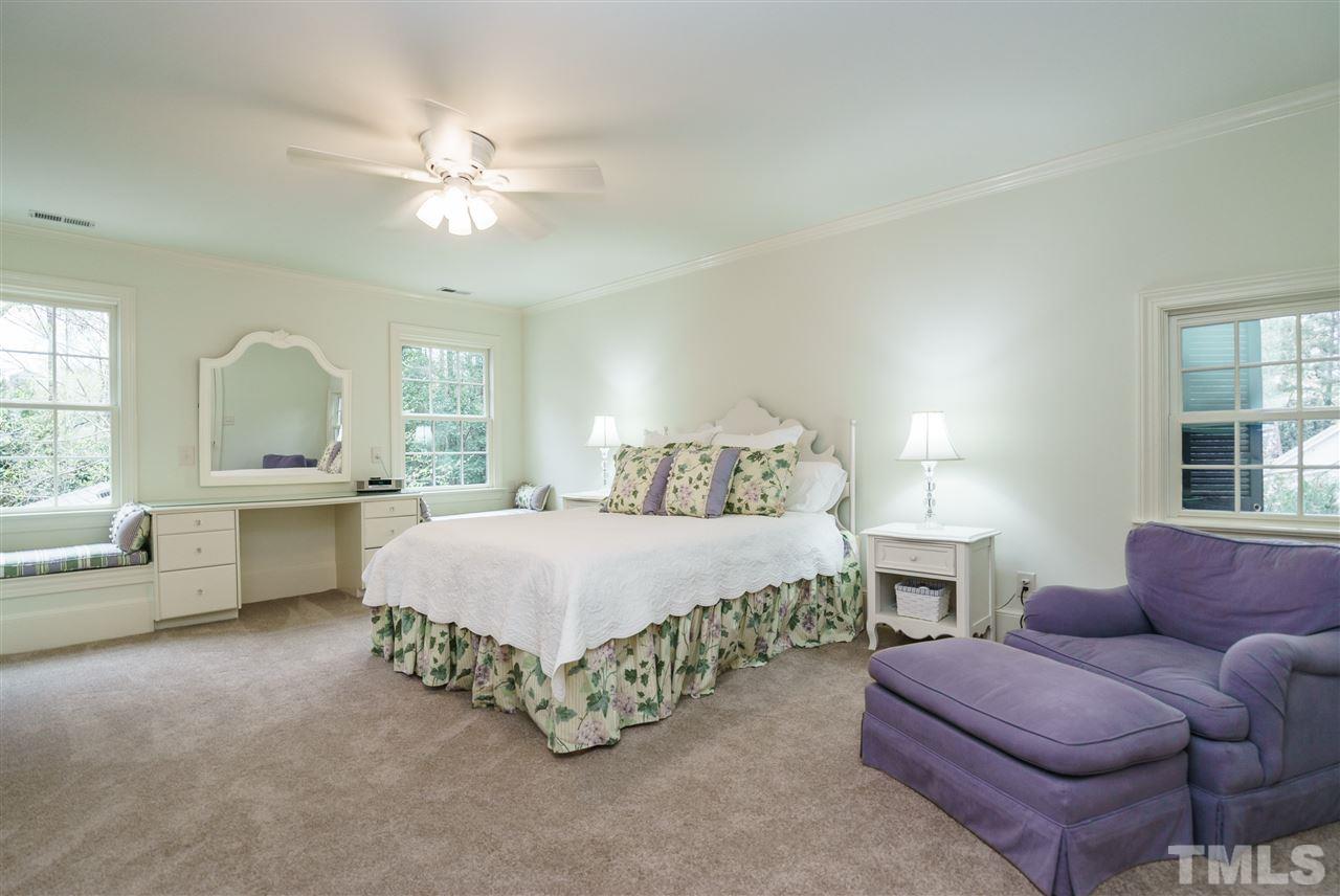 3202 Birnamwood Road Raleigh, NC 27607 - Photo 16 of 25 a spacious bedroom with a bed a couch and dresser