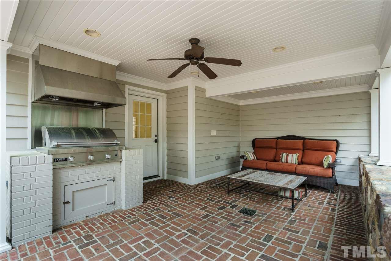 3202 Birnamwood Road Raleigh, NC 27607 - Photo 23 of 25 a bedroom with furniture and a chandelier