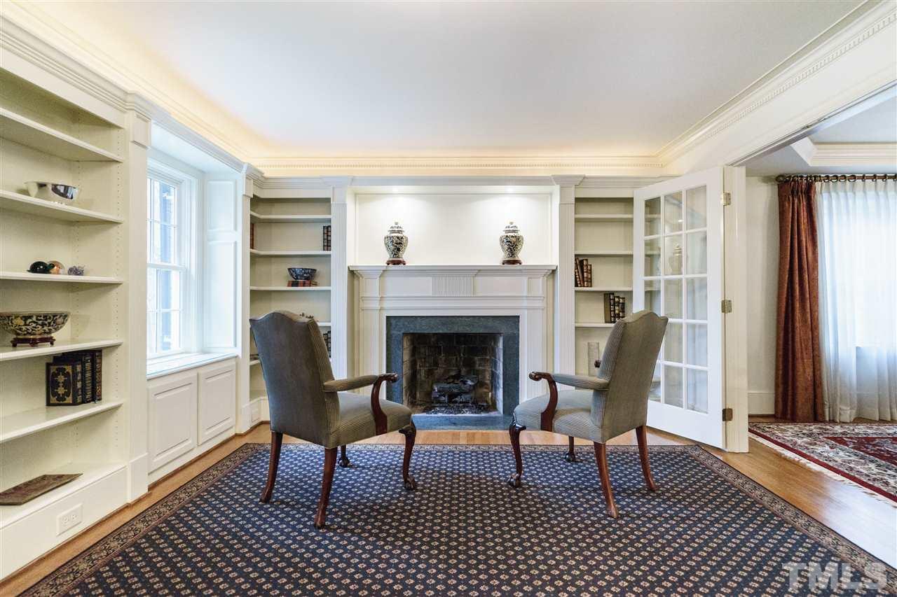 3202 Birnamwood Road Raleigh, NC 27607 - Photo 4 of 25 a living room with furniture and a fireplace