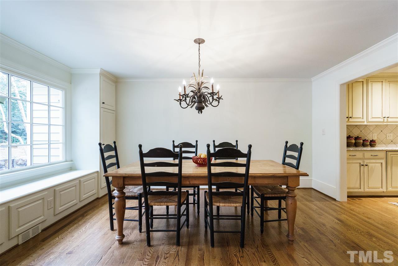 3202 Birnamwood Road Raleigh, NC 27607 - Photo 8 of 25 a view of a dining room with furniture window and wooden floor