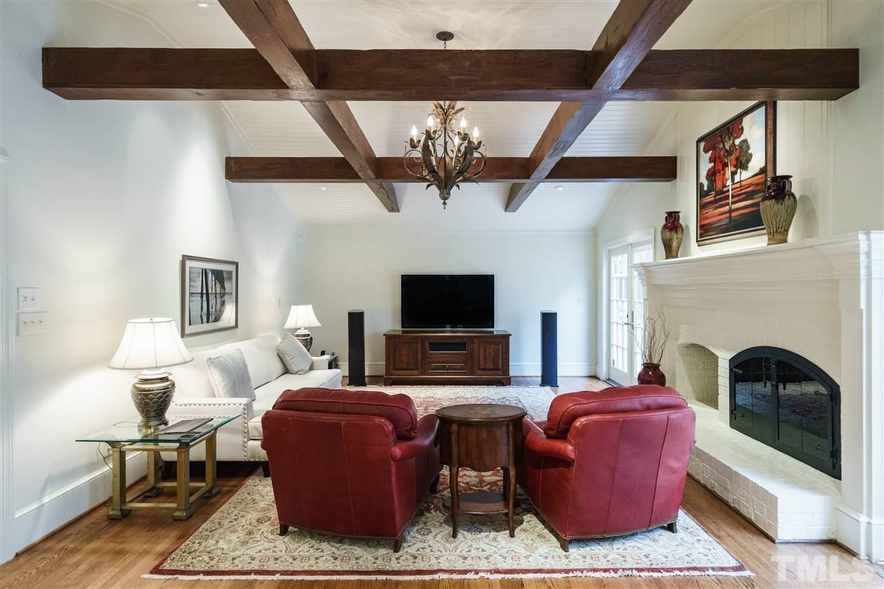 3202 Birnamwood Road Raleigh, NC 27607 - Photo 9 of 25 a living room with furniture a flat screen tv and a fireplace