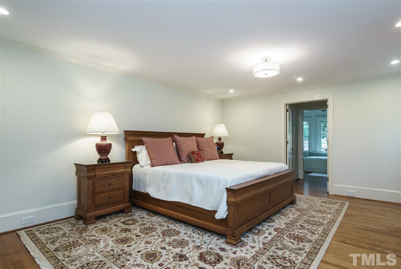 3202 Birnamwood Road Raleigh, NC 27607 - Photo 10 of 25 a bedroom with a bed and lamp