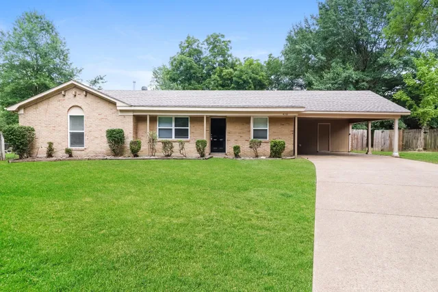 a front view of house with yard and green space