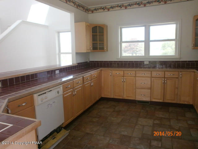 2201 Storm Road Stroudsburg, PA 18360 - Photo 3 of 12 a kitchen with granite countertop white cabinets sink and window