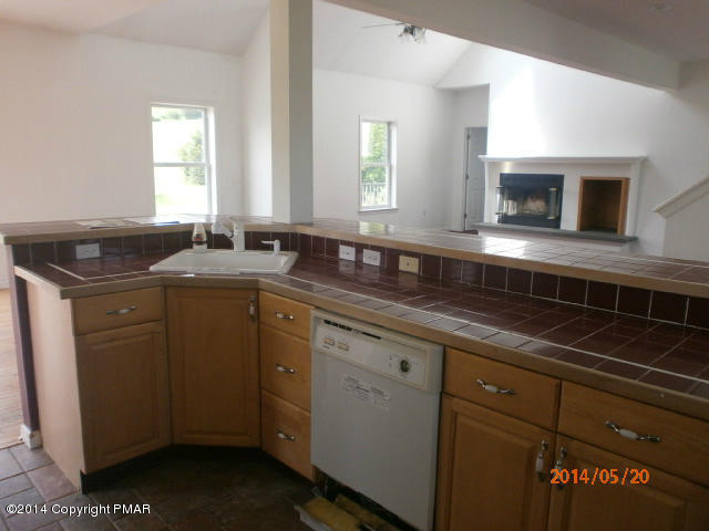 2201 Storm Road Stroudsburg, PA 18360 - Photo 4 of 12 a sink with granite countertop cabinets and window