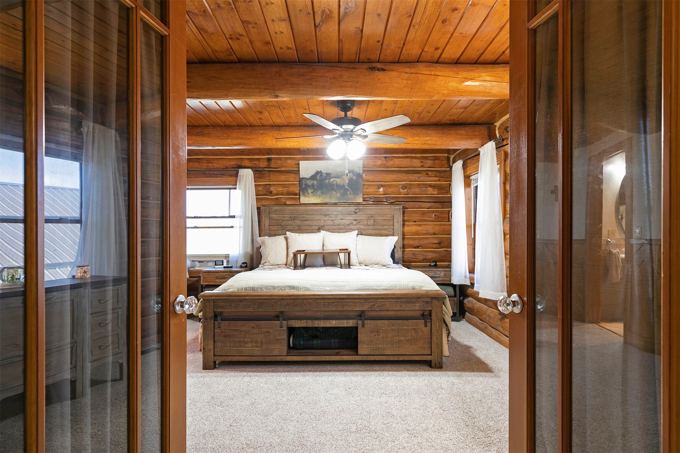 203 Hart Bench Road Darby, MT 59829 - Photo 20 of 56 From the landing, elegant French doors open into the expansive primary en suite, a private retreat that blends comfort with Montana-inspired sophistication