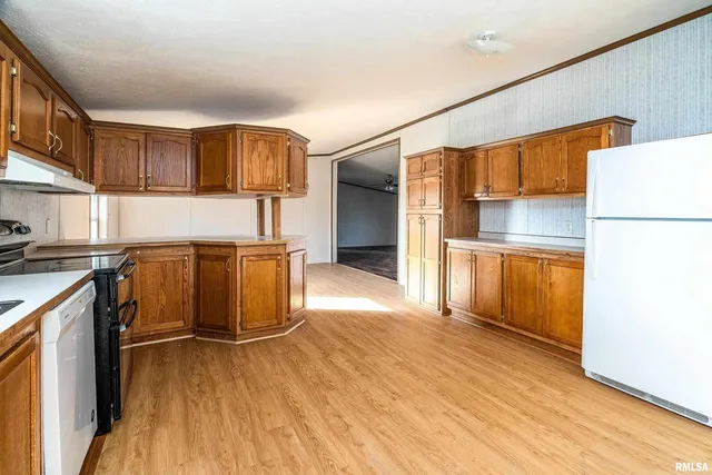 a kitchen with stainless steel appliances granite countertop a stove top oven sink and cabinets