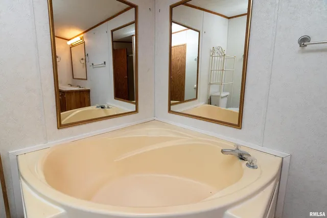 a bathroom with a tub and shower