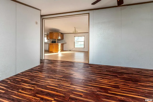 a view of empty room with a fireplace and window