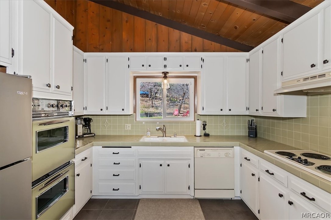 27994 West Shore Road Lake Arrowhead, CA 92352 - Photo 13 of 30 a kitchen with granite countertop white cabinets and white appliances