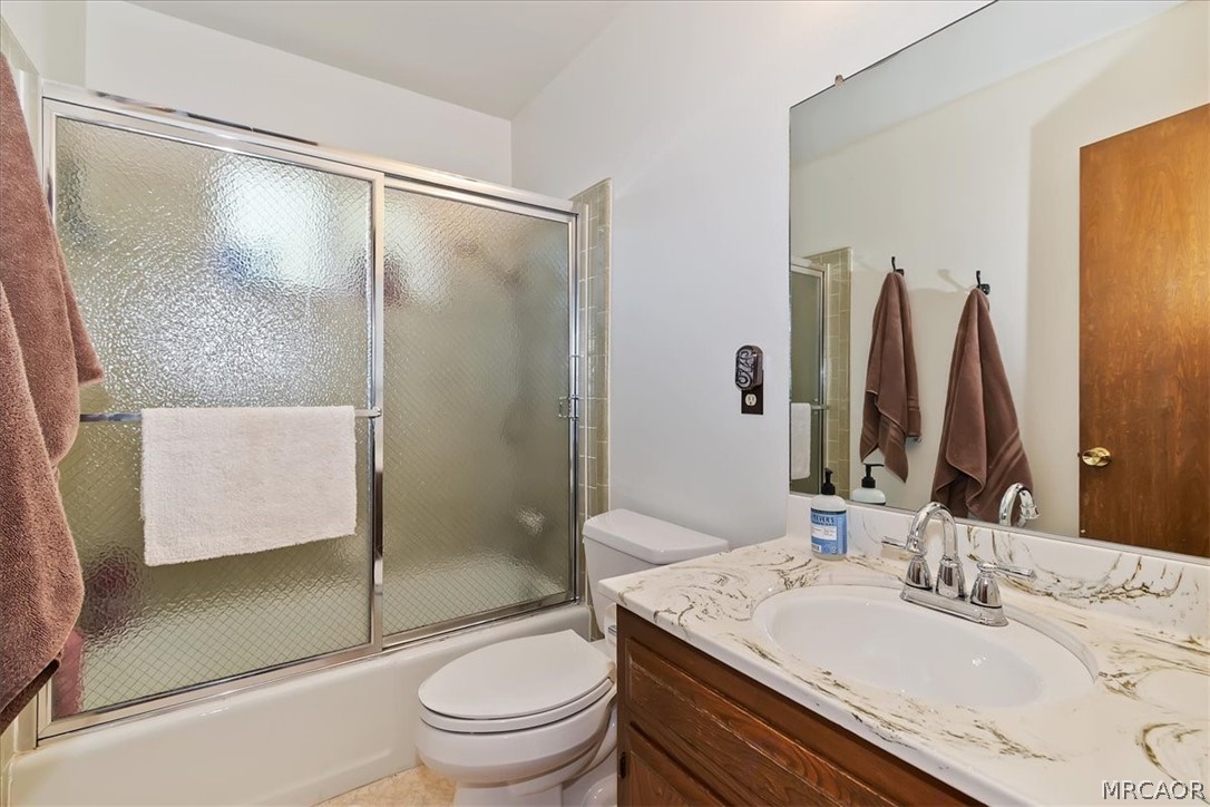 27994 West Shore Road Lake Arrowhead, CA 92352 - Photo 17 of 30 a bathroom with a granite countertop sink toilet and shower
