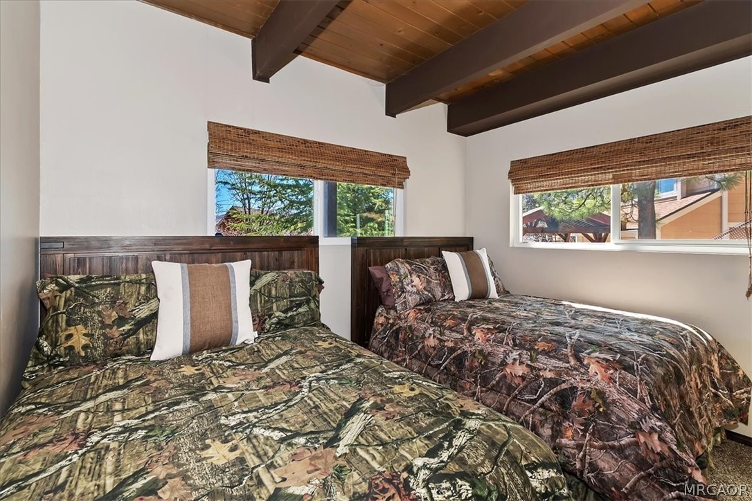 27994 West Shore Road Lake Arrowhead, CA 92352 - Photo 21 of 30 a bed sitting in a bedroom next to a window