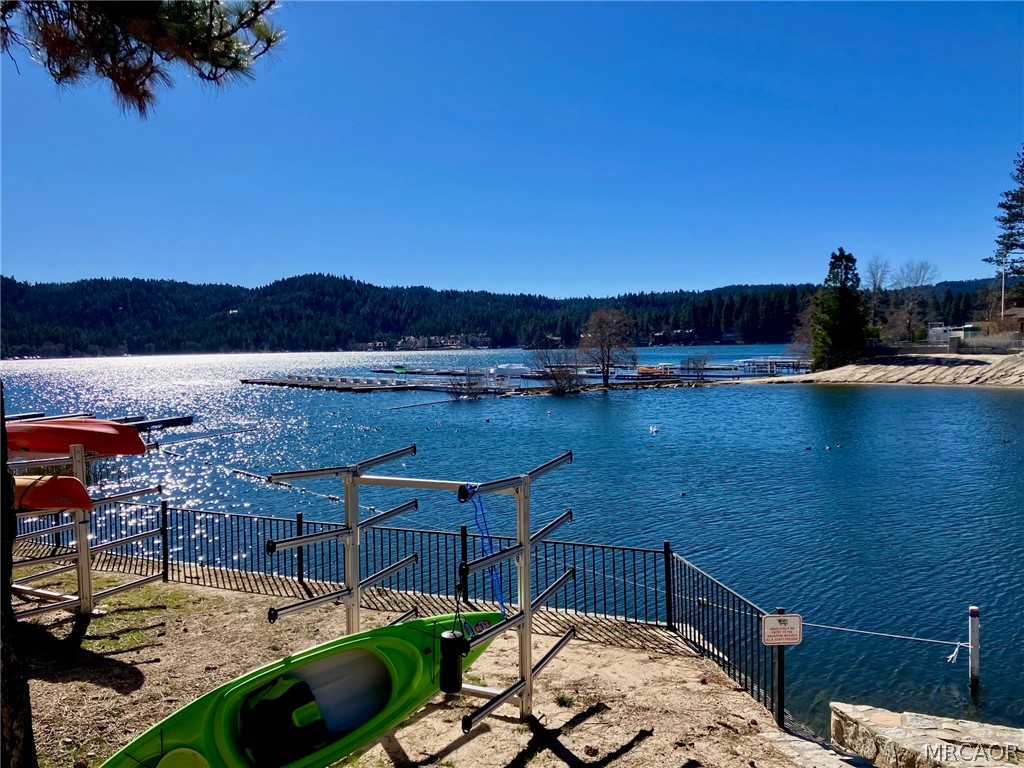 27994 West Shore Road Lake Arrowhead, CA 92352 - Photo 3 of 30 a view of a terrace with a table and chairs under an umbrella