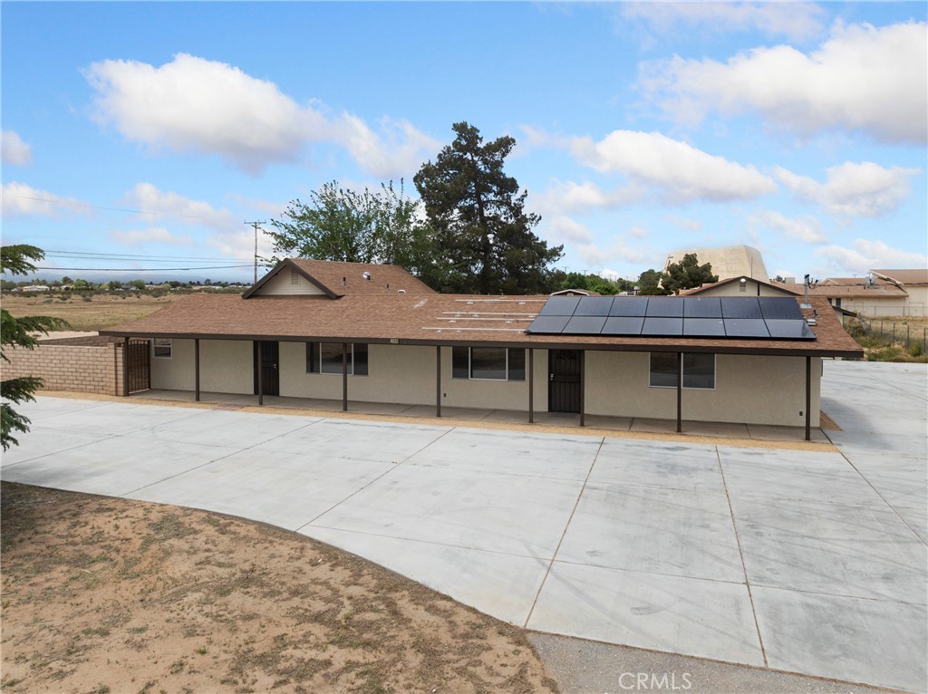 12920 Central Road Apple Valley, CA 92308 - Photo 1 of 1 a front view of a house with a yard and garage