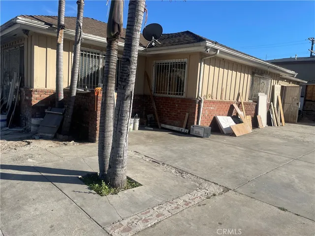 a view of a house with a door and wooden fence
