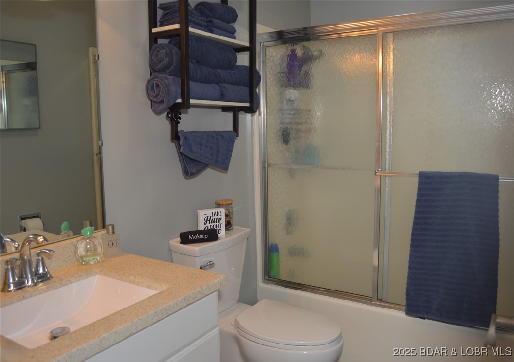 1442 Nichols Road, Unit B304 Osage Beach, MO 65065 - Photo 11 of 31 Bathroom with sliding shower doors