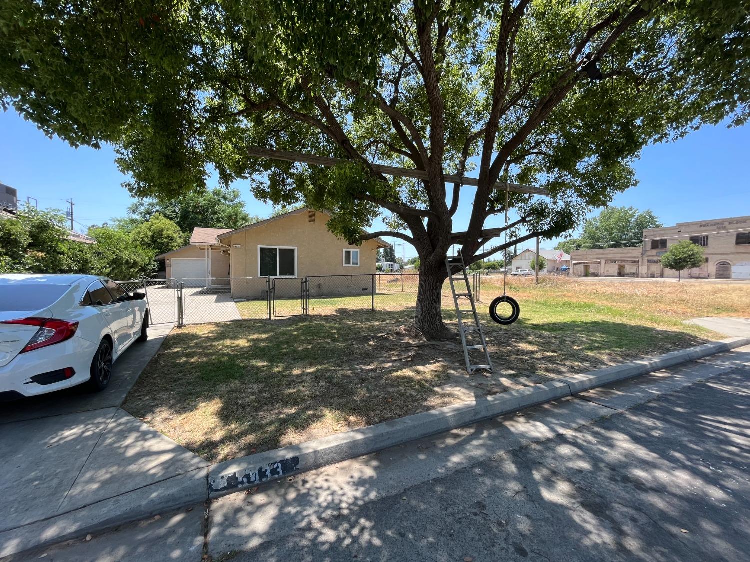 5433 Wildwood Del Rey, CA 93616 - Photo 1 of 17 a house view with a backyard space