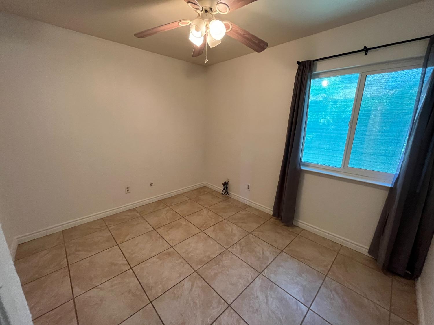 5433 Wildwood Del Rey, CA 93616 - Photo 11 of 17 a view of a livingroom with a chandelier fan and window