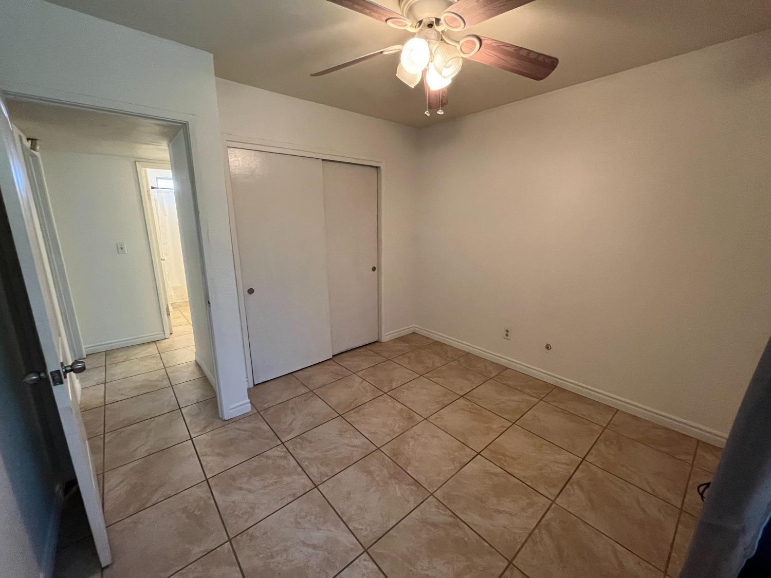 5433 Wildwood Del Rey, CA 93616 - Photo 12 of 17 en empty room with fan and glass door