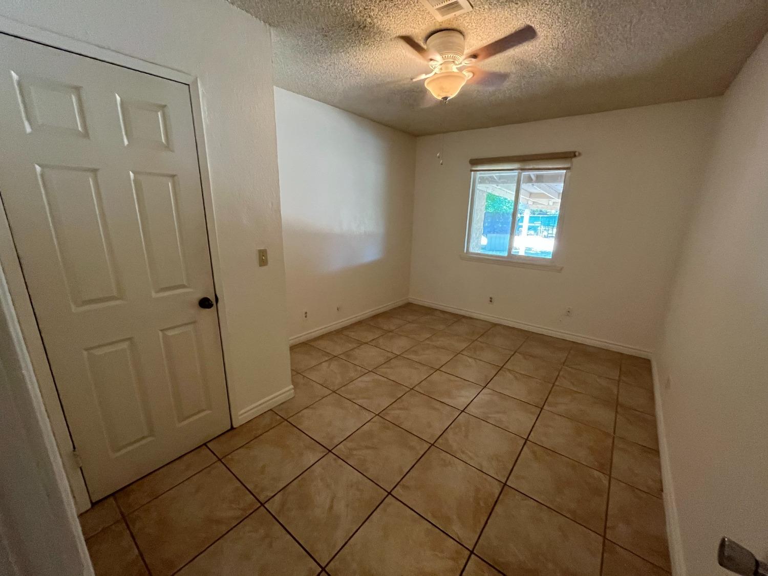 5433 Wildwood Del Rey, CA 93616 - Photo 13 of 17 a view of an empty room with a window