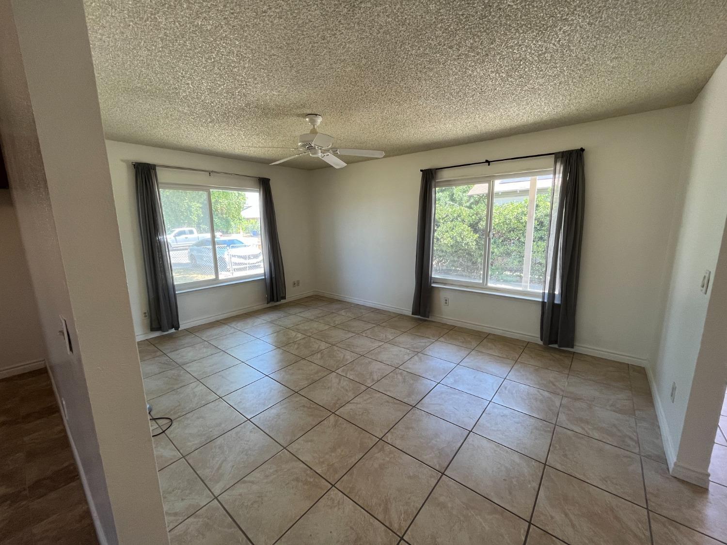 5433 Wildwood Del Rey, CA 93616 - Photo 3 of 17 an empty room with windows