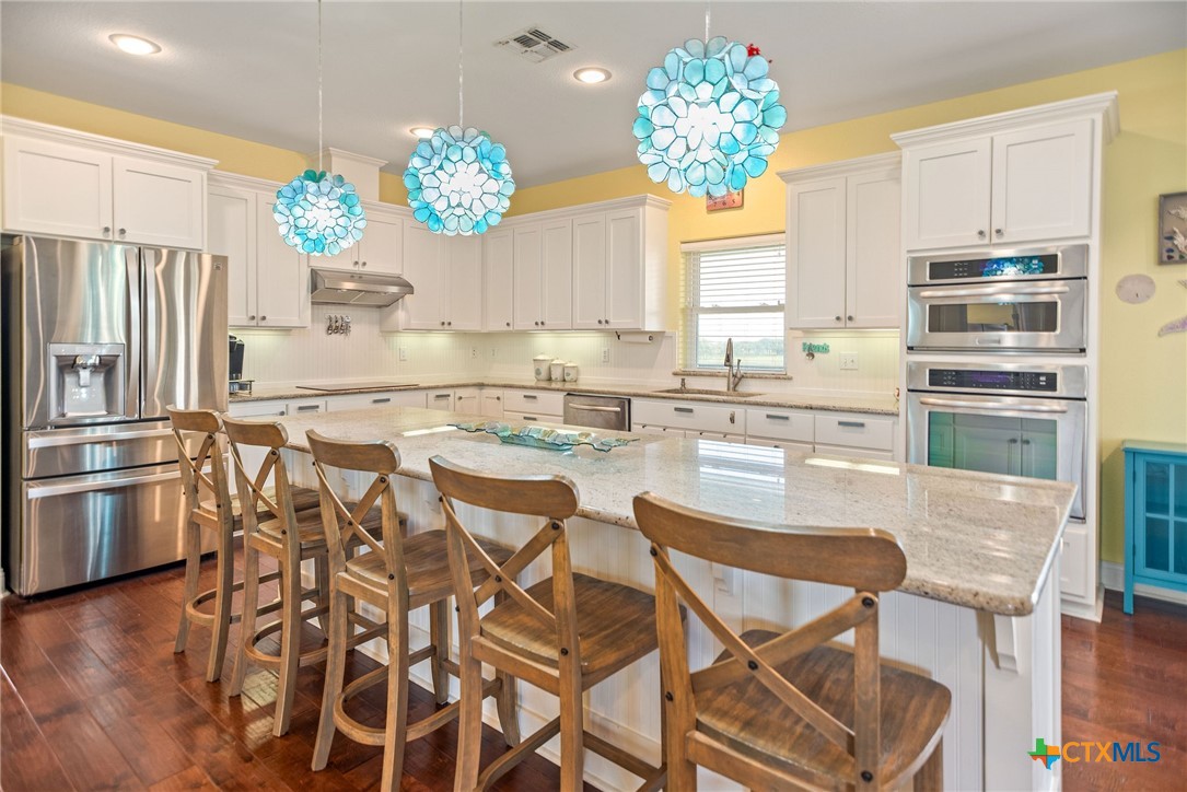 23 Macey Street Port O'Connor, TX 77982 - Photo 23 of 47 a kitchen with a table and chairs in it